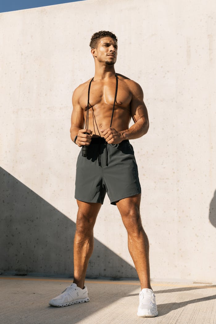 cta-bg Shirtless man working out on a rooftop in Austin, Texas, showcasing fitness and lifestyle.