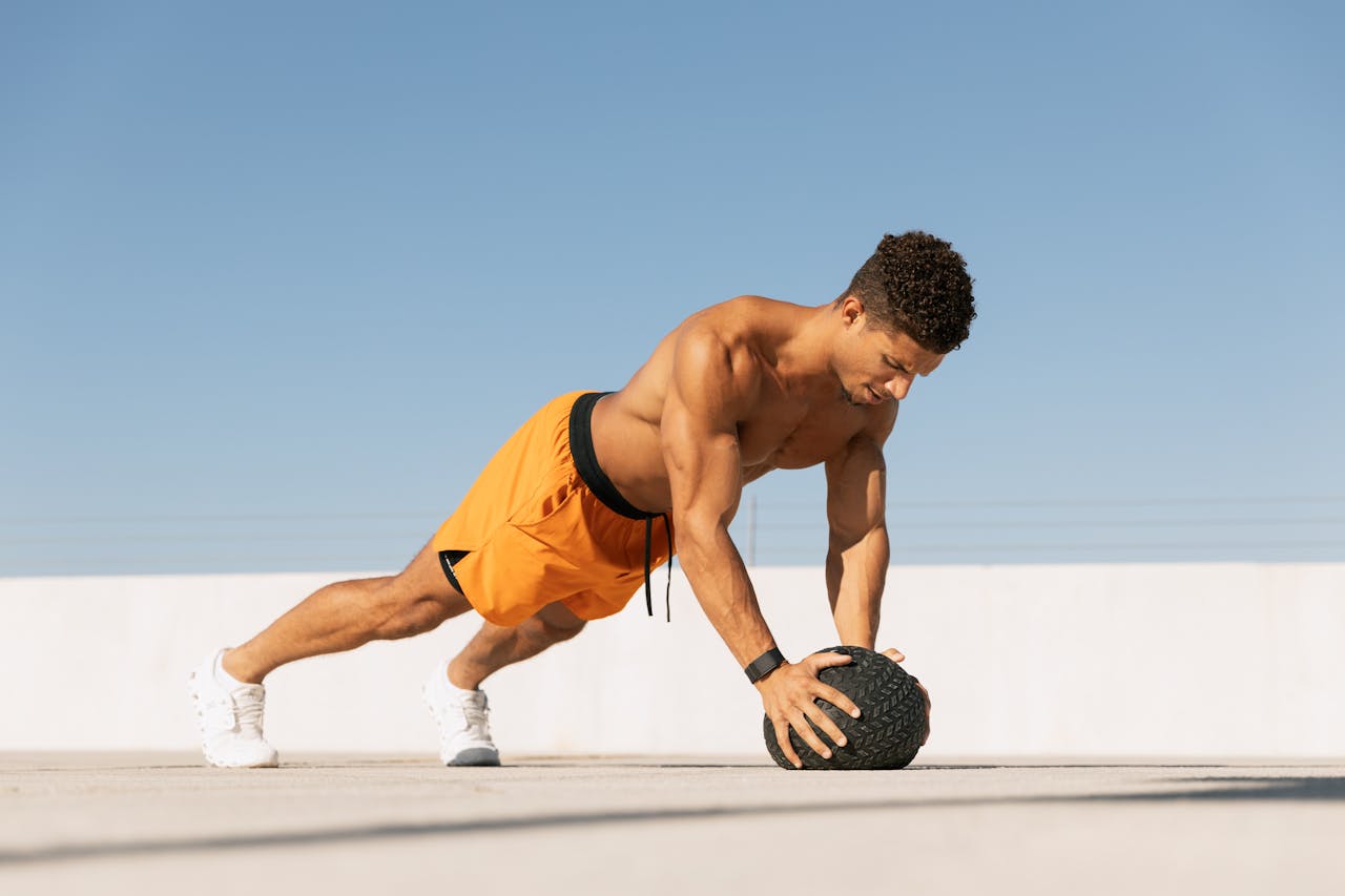testimonials-img Athletic man performing a workout with a medicine ball on a sunny rooftop in Austin, Texas.
